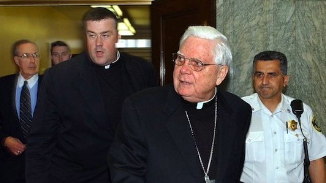 Alumni uncovered how the Catholic Church allowed abuse by priest for years (Photo by David L. Ryan/The Boston Globe). Two priests escorted by a security guard.