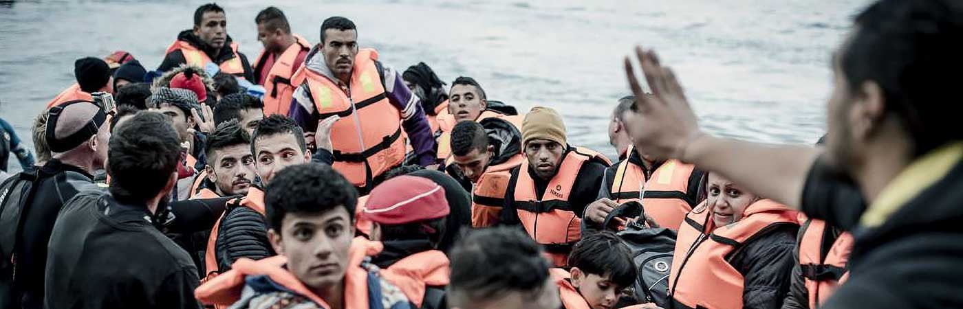 a life boat full of refugees wearing life vests