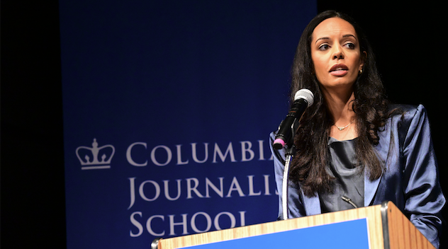 A woman stands at a podium with the Columbia Journalism School logo visible in the background.