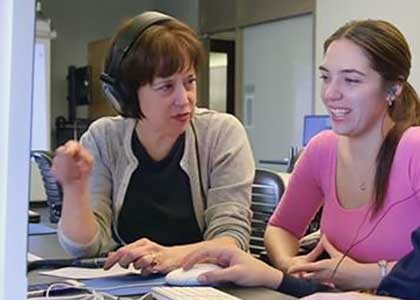 female professor sitting with female student in conversation