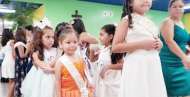 small children in formal gowns at a beauty contest
