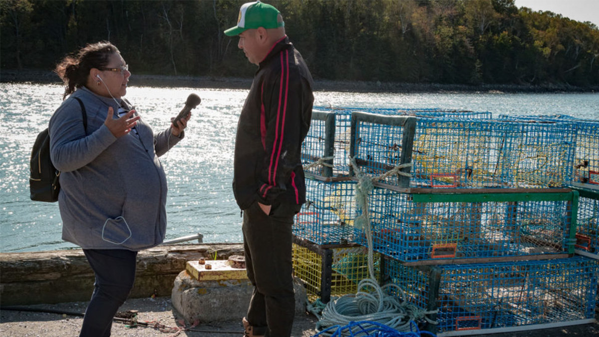 Maureen Googoo, '07 M.S., conducting an interview at the Weymouth wharf outside Saulnierville, Nova Scotia for Ku’ku’kwes. Maureen Googoo, '07 M.S., conducting an interview at the Weymouth wharf outside Saulnierville, Nova Scotia for Ku’ku’kwes.