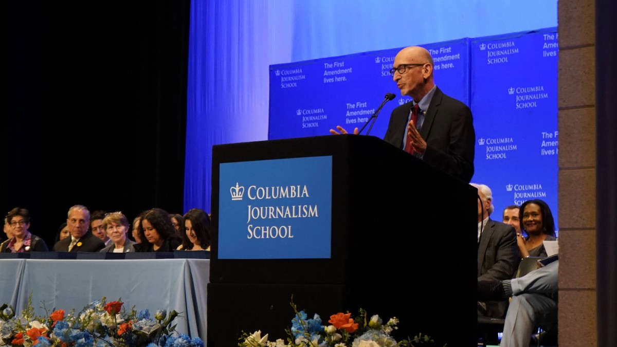 Man speaking at a podium.