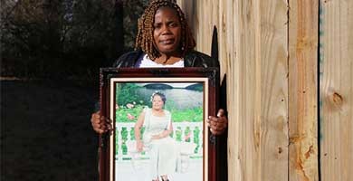 Woman holding a photograph of another woman