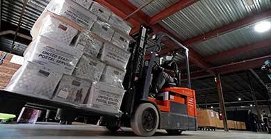 A forklift operator loads absentee ballots for mailing on Sept. 3, 2020, in Raleigh, North Carolina. (Gerry Broome/AP)