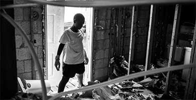 A boy helps clean up debris inside a collapsed church in Marsh Harbour, in the Abaco Islands.Photographs by Cristina Baussan