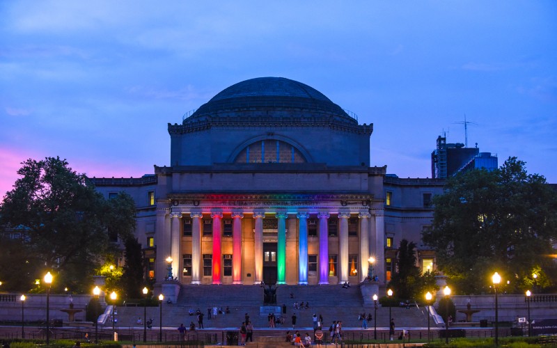 Low Library lit up in a rainbow flag