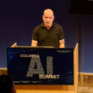 Mark Hansen, Director of the Brown Center for Media Innovation, is joined by other interdisciplinary researchers at Columbia who are integrating AI into their creative practice during a "AI and Creativity" discussion. Man presenting at a podium that reads "Columbia AI Summit."
