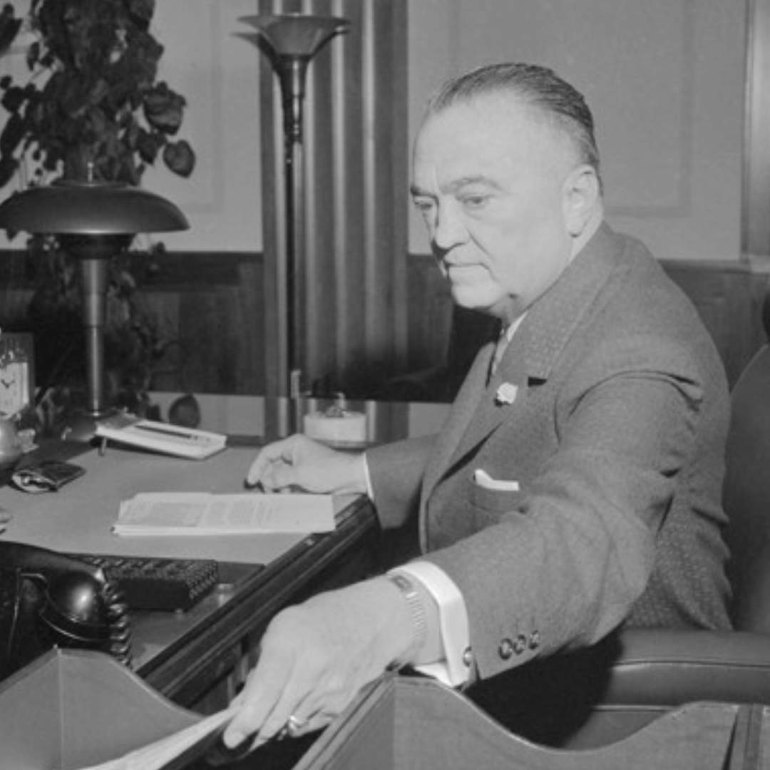 As an NBC News reporter, Carl Stern, ’59 M.S., used the Freedom of Information Act to expose the FBI’s secret counterintelligence programs led by J. Edgar Hoover. Photo by Bettmann/Corbis. Black and white photo of a man working at a desk.