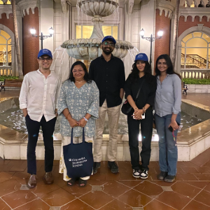 Associate Dean Anusha Shrivastava, ’02 M.S., visits newsrooms and universities across India this spring, connecting with prospective and admitted students and building academic partnerships. Five individuals pose for a photo in front of a fountain.