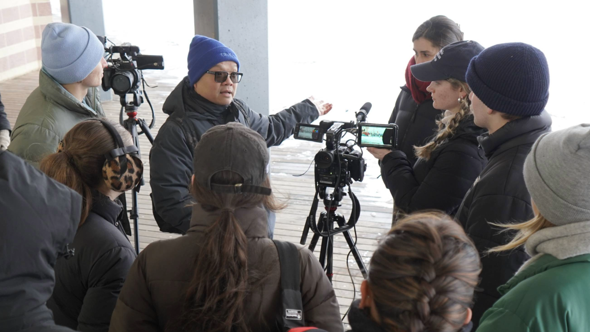 Group of students listening to a professor.