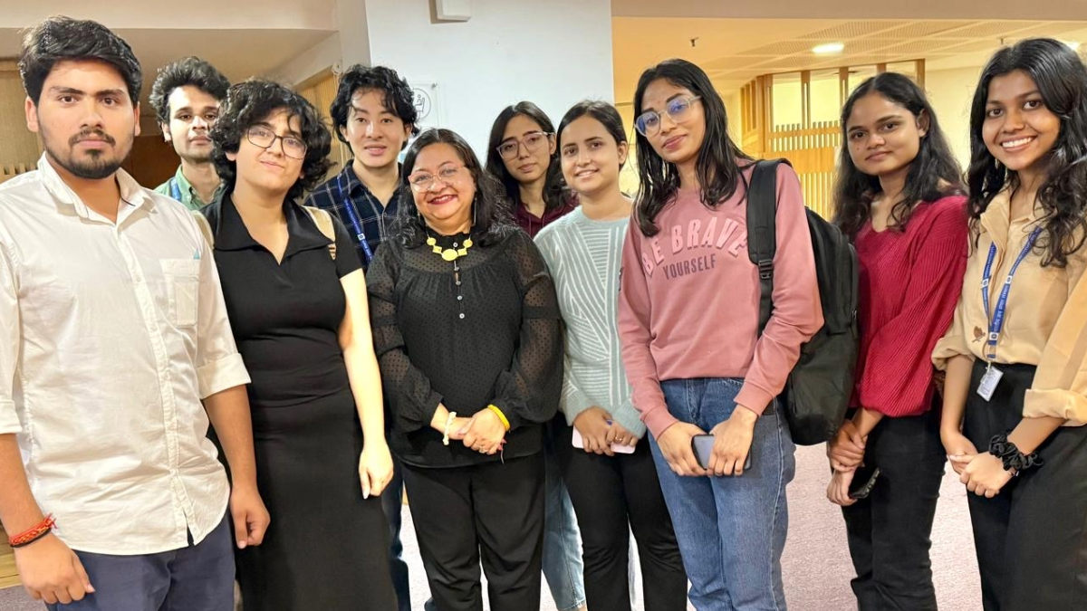 Associate Dean of Career Development Anusha Shrivastava, Ph.D., '02 M.S., with J-School prospective students and alumni in New Delhi. Ten people stand next to each other in a building in New Delhi
