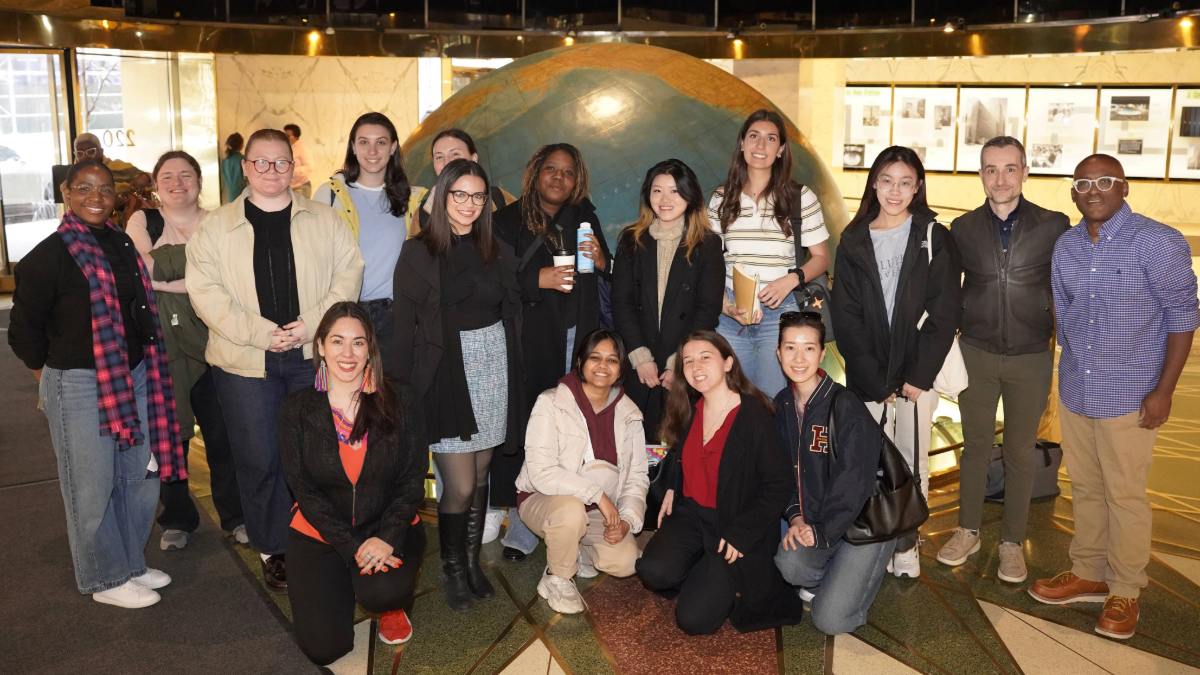 A large group photographed in the lobby of a building. 
