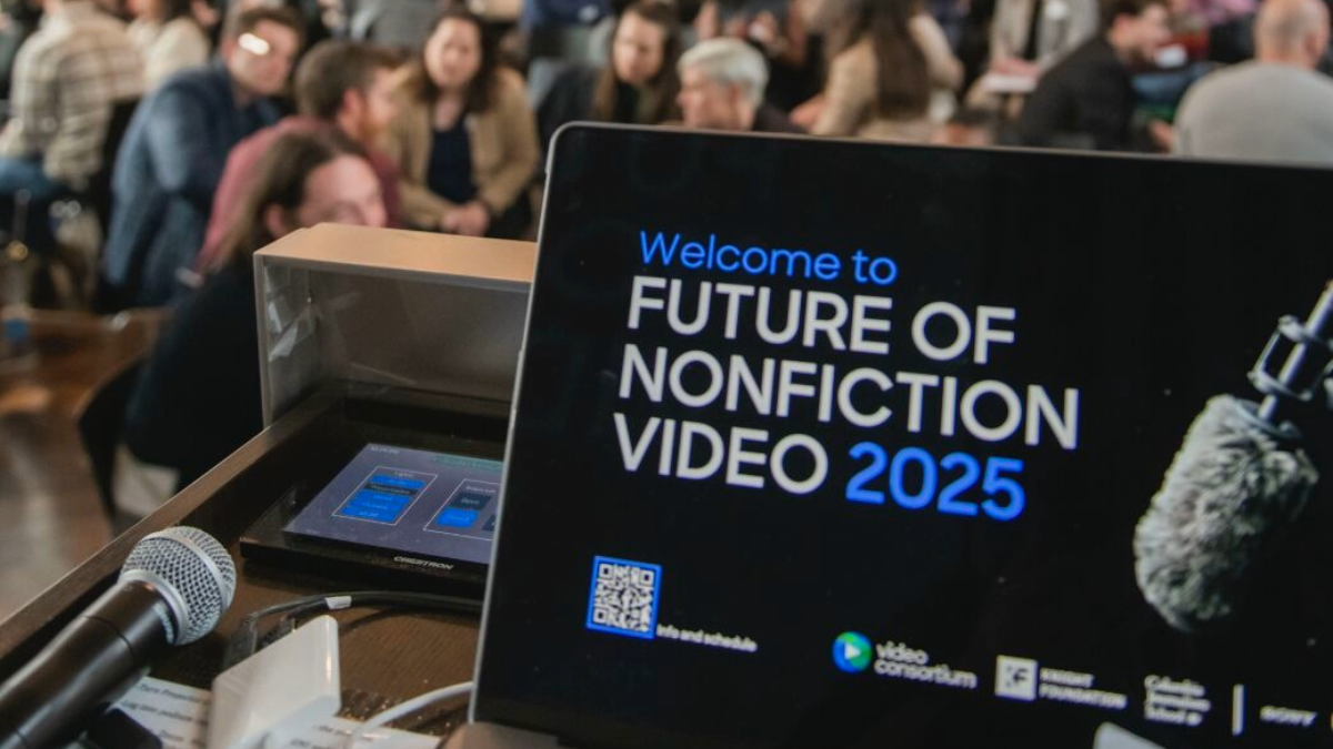 A laptop screen on a podium displaying "Welcome to Future of Nonfiction Video 2025."