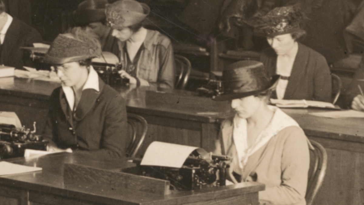 Historic photo of four women in 1918 typing. 