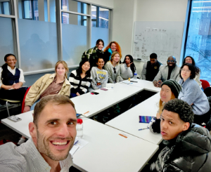 Jacob Kushner's class during a trip to two New York immigration courts. A selfie taken in a classroom with a group of students.