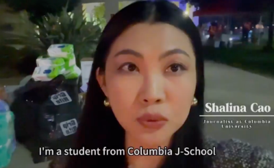 Shalina Xufang Cao, '25 M.A. Politics, reporting on the Los Angeles wildfires for Columbia News Service before interviewing evacuees. Woman reporting from her phone at night.
