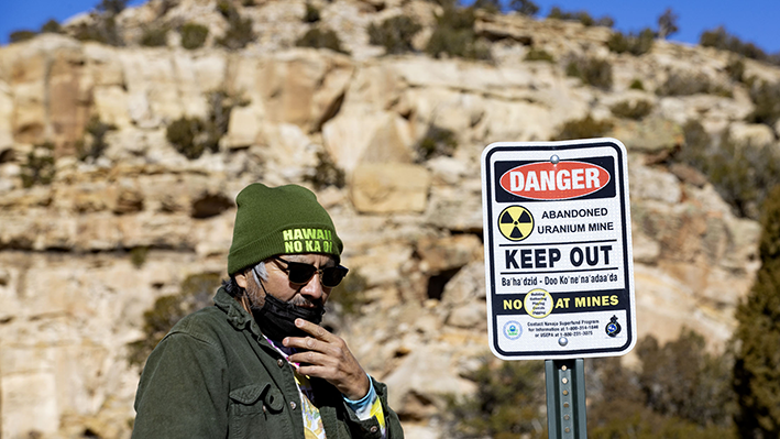  Earl Tulley beside a "keep out" sign