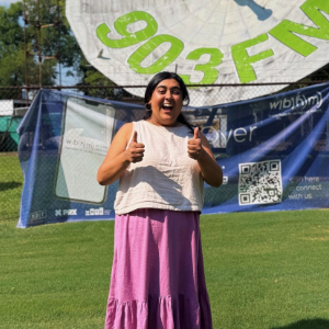 Vahini Shori, '25 M.S., joins Report for America in Alabama, covering how faith shapes social life, medicine and politics. (Credit: Vahini Shori) A woman is standing in front of a satellite dish.