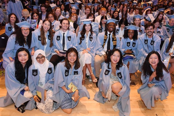 Students sitting together at the graduation ceremony. 