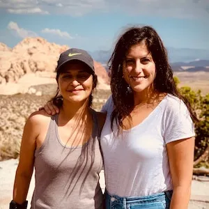 Nina Alvarez and Caterina Barbera-Kipreos with rocky hills and mountains in the background.
