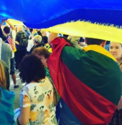 people carrying flags on protest march