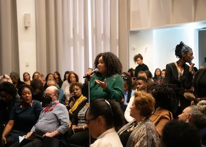 Person asking a question during the Ida B. Wells Symposium