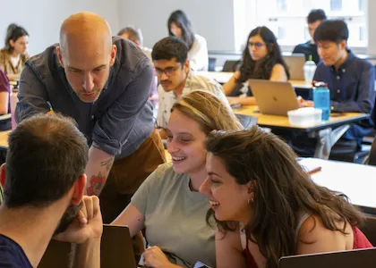 Professor Jonathan Soma assisting students in class. 