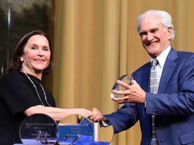 An alumna receives a CJS Alumni Award during the 2025 ceremony. 