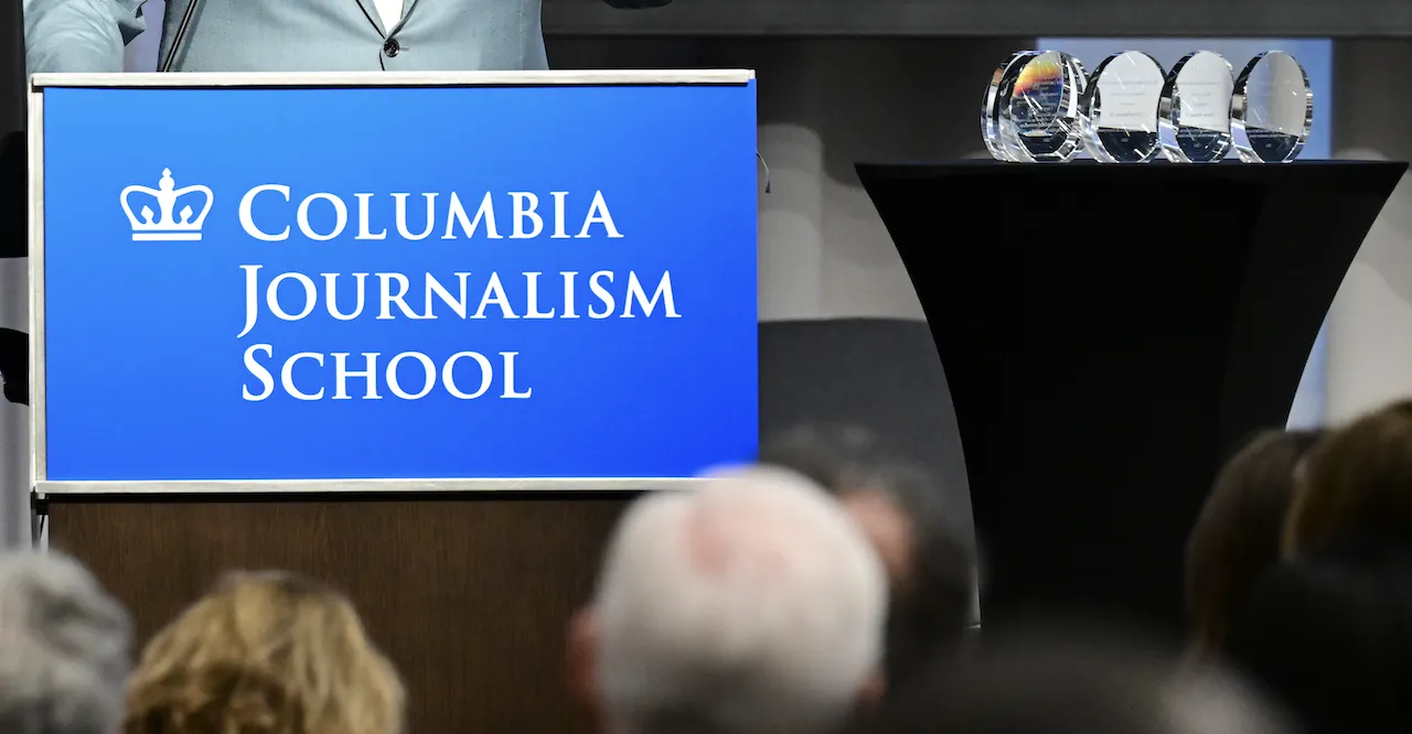 A J-School podium and set of awards. 