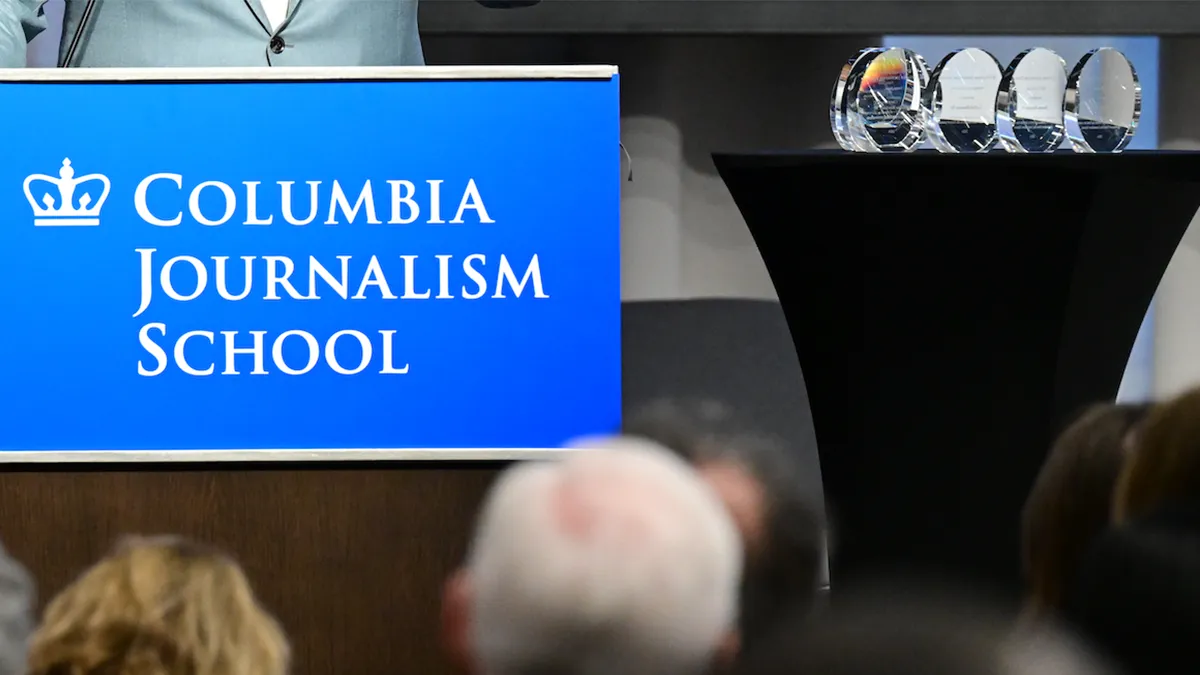 Podium with the CJS logo. 