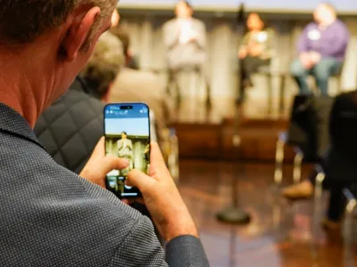 Man filmed through the lens of a smartphone. 