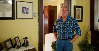 Ernie Haynes stands next to a memorial for his daughter, Jennifer, at his home in Risingsun, Ohio. Following her drug overdose death in 2017, he was charged with abduction after trying to gain custody of his grandchildren. The action sparked a five-year legal battle to clear his name.  Dustin Franz for NPR