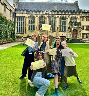 Lexi Baker, Delaney Brown, Ashley Blaes, Carina Mignon and Elizabeth Halleron of the 2024 class celebrate receiving their certificates on the main quad of Exeter on the last day of the course.