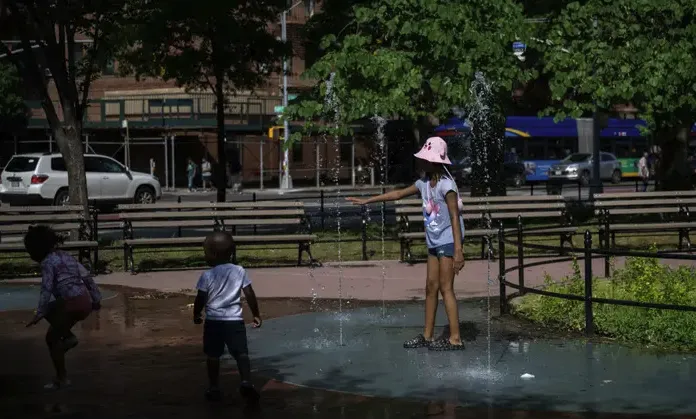 Children playing in a park. Angela Weiss / AFP via Getty Images. 