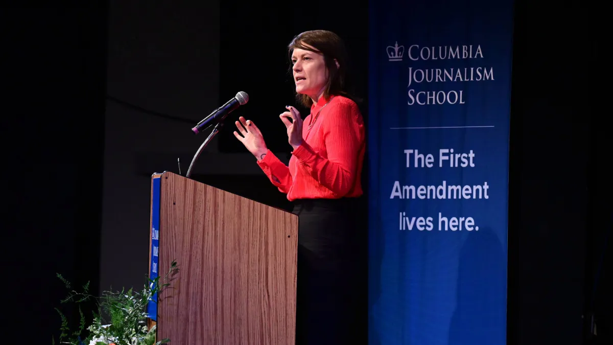Woman speaking at a podium