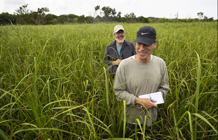 Tony Bartelme, foreground, with fellow reporter Glenn Smith, reporting from within the threatened Santee Delta. Photo: Lauren Petracca/The Post and Courier