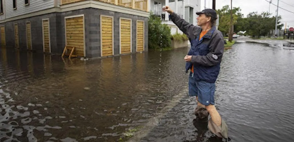 Bartelme wading into 2020 floodwaters to test for bacteria levels for a report on the threat of sunny-day tidal floods.