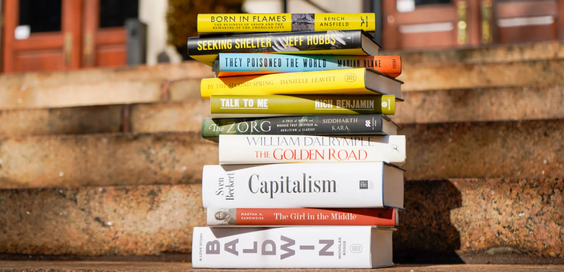 Book covers of the 2026 Lukas Prize shortlist photographed outside. 