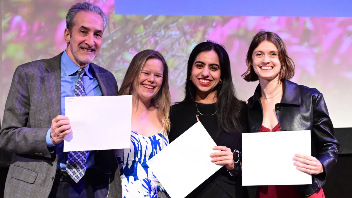 Professor awards three students. 