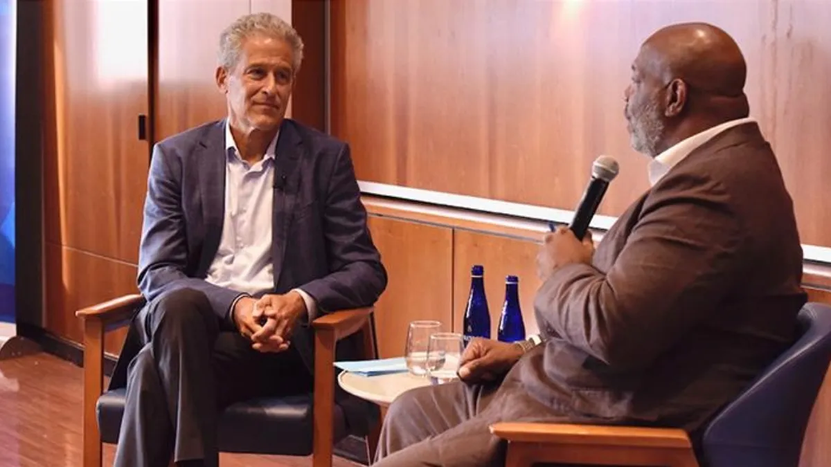 Two people participating in a panel discussion. 