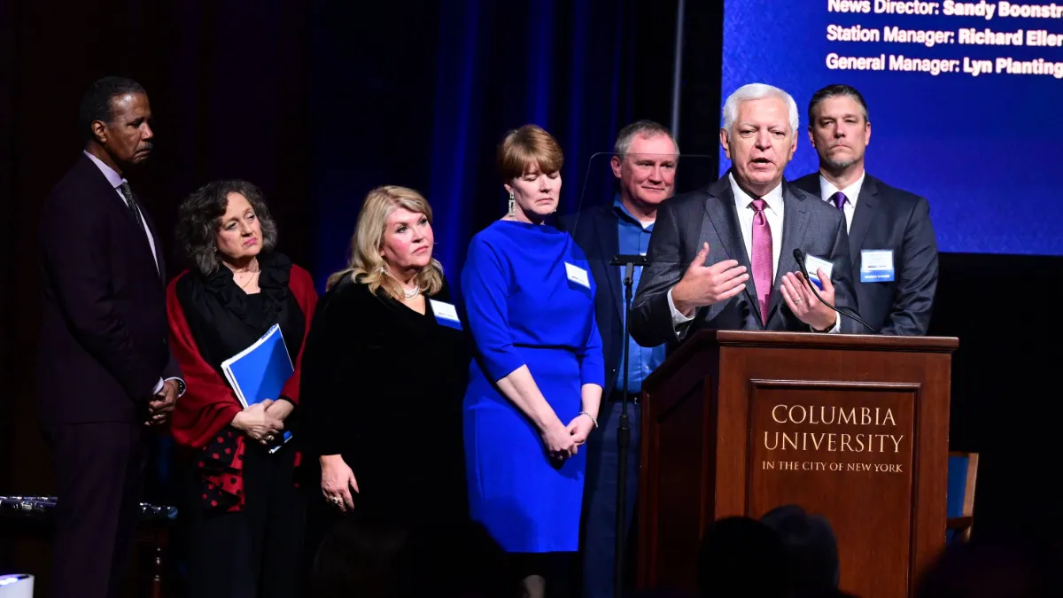 Phil Williams stands near a podium and addresses the audience as he accepts his fifth duPont-Columbia Award
