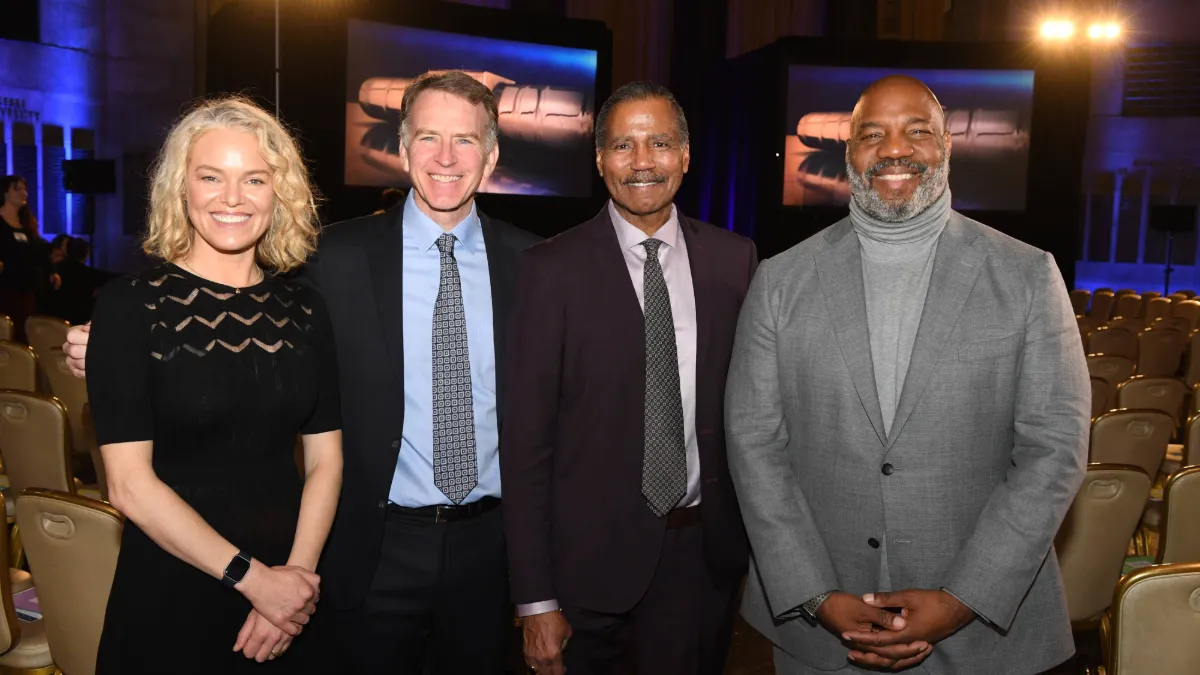 Katherine Maher, Steve Inskeep, Bill Whitaker, and Dean Jelani Cobb stand from left to right in a group photo