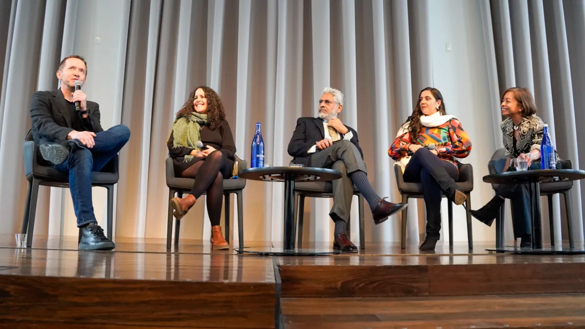 A five person panel on stage. 