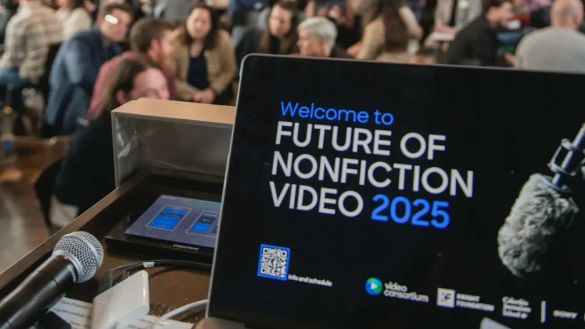 A laptop screen on a podium displaying "Welcome to Future of Nonfiction Video 2025."
