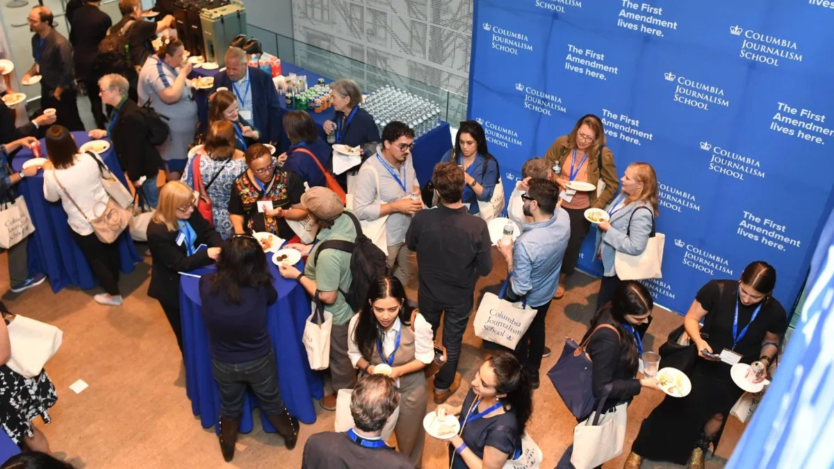 People gathered in an event space photographed from above. 