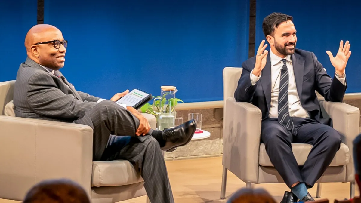 Two men in discussion during a panel. 