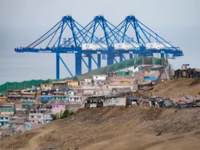 The cranes of a new megaport tower behind the town of Chancay, Peru. Credit: Cris Bouroncle/AFP via Getty Images Image courtesy of Inside Climate News.