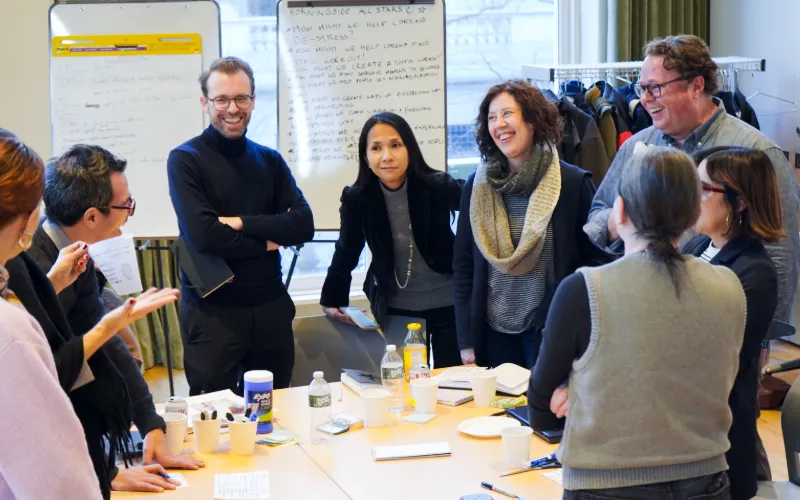 Group of professionals gather around a table. 