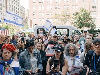People held Israeli flags and images of hostages held by Hamas outside Columbia University on Monday, while on the campus itself, two groups of students rallied, one in support of Israel and the other in support of Palestinians.Credit...Jeenah Moon for The New York Times